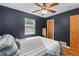 Stylish bedroom showcases hardwood floors, a modern ceiling fan, natural light, and closet at 1540 Filbert Ct, Denver, CO 80220