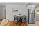 Cozy dining area with modern table and chairs, next to stainless steel refrigerator at 1540 Filbert Ct, Denver, CO 80220