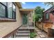 Welcoming entrance with steps leading to a charming brick home with vintage details at 1540 Filbert Ct, Denver, CO 80220