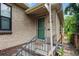 Charming brick home features a cozy entrance with a vintage door and metal railing at 1540 Filbert Ct, Denver, CO 80220