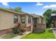 Inviting front yard with a brick house featuring roses, a green lawn, and a wood fence at 1540 Filbert Ct, Denver, CO 80220