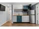 Modern kitchen with butcher block counters, stainless appliances and wood floors at 1540 Filbert Ct, Denver, CO 80220