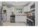Kitchen featuring white cabinets, wood countertops, stainless steel appliances, subway tile backsplash, and natural light at 1540 Filbert Ct, Denver, CO 80220