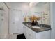 Bright bathroom with double vanity, granite countertop, and a glass-enclosed shower at 23670 E 41St Ave, Aurora, CO 80019