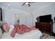 Bright and tidy bedroom with TV, dresser, and open doorway to bath at 23670 E 41St Ave, Aurora, CO 80019