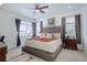 Bright bedroom features a cozy bed, side tables, and large windows at 23670 E 41St Ave, Aurora, CO 80019