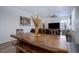 Dining room featuring a large wooden table with seating and a view into the living room area at 23670 E 41St Ave, Aurora, CO 80019