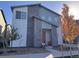 Attractive two-story home featuring diverse materials and colorful yard plants and an orange front door at 23670 E 41St Ave, Aurora, CO 80019
