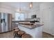 Open kitchen with a granite countertop island, modern lighting and stainless appliances at 23670 E 41St Ave, Aurora, CO 80019