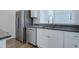 Kitchen featuring stainless steel appliances, including a refrigerator and dishwasher, with white cabinetry at 23670 E 41St Ave, Aurora, CO 80019