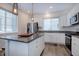 Bright kitchen featuring granite countertops, pendant lighting, stainless appliances, and white cabinetry at 23670 E 41St Ave, Aurora, CO 80019