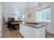 Open kitchen and dining area with stainless appliances and dining table with wooden barstool seating at 23670 E 41St Ave, Aurora, CO 80019