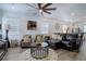 Comfortable living room with lots of seating, natural lighting and a view into the kitchen and dining area at 23670 E 41St Ave, Aurora, CO 80019