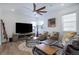 Bright living room featuring stylish furnishings and a modern ceiling fan at 23670 E 41St Ave, Aurora, CO 80019