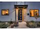 Modern front entrance with stone accents, dark-colored door, and landscape lighting at 291 S Franklin St, Denver, CO 80209