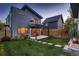 Two-story modern home with a balcony, landscaped yard, and wood fence at 291 S Franklin St, Denver, CO 80209