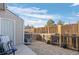 Backyard patio area with air conditioning unit and a fence at 4633 S Crystal Way # E189, Aurora, CO 80015