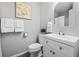 Bathroom featuring tile, modern art, and a sink with mirror at 4633 S Crystal Way # E189, Aurora, CO 80015