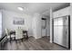 Open dining area with stainless steel refrigerator, dining table, and laundry closet at 4633 S Crystal Way # E189, Aurora, CO 80015