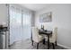 Cozy dining area featuring a dark wood table with seating for two and natural light from a sliding glass door at 4633 S Crystal Way # E189, Aurora, CO 80015