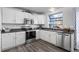 Bright kitchen featuring white cabinetry, stainless steel appliances, and modern countertops at 4633 S Crystal Way # E189, Aurora, CO 80015