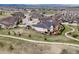 Aerial view of neighborhood highlighting home with solar panels and the walking path at 2351 Lassen Ln, Castle Rock, CO 80109