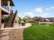 Spacious backyard with patio, firepit, and stairs to upper deck at 2351 Lassen Ln, Castle Rock, CO 80109