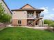 Backyard with stairs to upper deck, featuring a patio and green lawn at 2351 Lassen Ln, Castle Rock, CO 80109