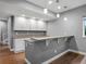 Finished basement bar area with modern lighting, custom cabinets and countertops on a wood floor at 2351 Lassen Ln, Castle Rock, CO 80109