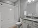 Well-lit bathroom featuring a shower-tub combo and neutral wall color at 2351 Lassen Ln, Castle Rock, CO 80109