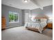 Spacious bedroom with large window, carpet floors, and a wooden bed frame at 2351 Lassen Ln, Castle Rock, CO 80109