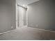 A clean, empty room with neutral walls, carpet and a hallway featuring several entryways to other rooms at 2351 Lassen Ln, Castle Rock, CO 80109