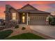 Charming home with a stone chimney and well-maintained landscaping during an eye-catching sunset at 2351 Lassen Ln, Castle Rock, CO 80109