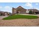 Inviting exterior view showcasing the well-maintained lawn and stone accents of this lovely home at 2351 Lassen Ln, Castle Rock, CO 80109
