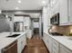 Modern kitchen features stainless steel appliances, white cabinetry, and a stylish tile backsplash at 2351 Lassen Ln, Castle Rock, CO 80109