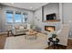 Cozy living room with stone fireplace, large windows, and comfortable seating at 2351 Lassen Ln, Castle Rock, CO 80109