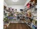 Walk-in pantry with organized shelving and hardwood flooring at 2351 Lassen Ln, Castle Rock, CO 80109