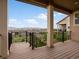Outdoor living area with wooden patio, black railing, and neighborhood views at 2351 Lassen Ln, Castle Rock, CO 80109
