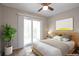 A light-filled bedroom boasts a ceiling fan and a sliding glass door to the outside at 5770 E Warren Ave # 206, Denver, CO 80222