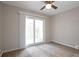 Bright bedroom featuring a ceiling fan and sliding glass doors to a balcony at 5770 E Warren Ave # 206, Denver, CO 80222