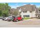 Three-story apartment building featuring white exterior, brown roof, and multiple parked cars in a lot at 5770 E Warren Ave # 206, Denver, CO 80222