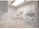 Bright kitchen with white cabinets, stone countertops, and modern appliances at 5770 E Warren Ave # 206, Denver, CO 80222