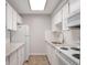 Bright kitchen features white appliances, cabinets, and stone countertops at 5770 E Warren Ave # 206, Denver, CO 80222