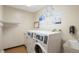 On-site laundry room with multiple machines and signage detailing laundry tips and app usage at 5770 E Warren Ave # 206, Denver, CO 80222