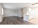 Well-lit living room with hardwood floors and view of kitchen with breakfast bar at 5770 E Warren Ave # 206, Denver, CO 80222