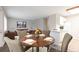 A dining table is featured in a bright room connected to a living room at 5770 E Warren Ave # 206, Denver, CO 80222