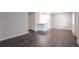 An open-concept space with wood floors leads to a kitchen featuring a breakfast bar at 5770 E Warren Ave # 206, Denver, CO 80222