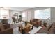 Bright living room boasts modern furnishings, dark wood floors, and is virtually staged at 5770 E Warren Ave # 206, Denver, CO 80222