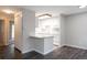 A view of a kitchen featuring a breakfast bar and white cabinets with white appliances at 5770 E Warren Ave # 206, Denver, CO 80222