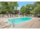 Community pool featuring lounge chairs with lifeguard ring and trees in the background at 5770 E Warren Ave # 206, Denver, CO 80222